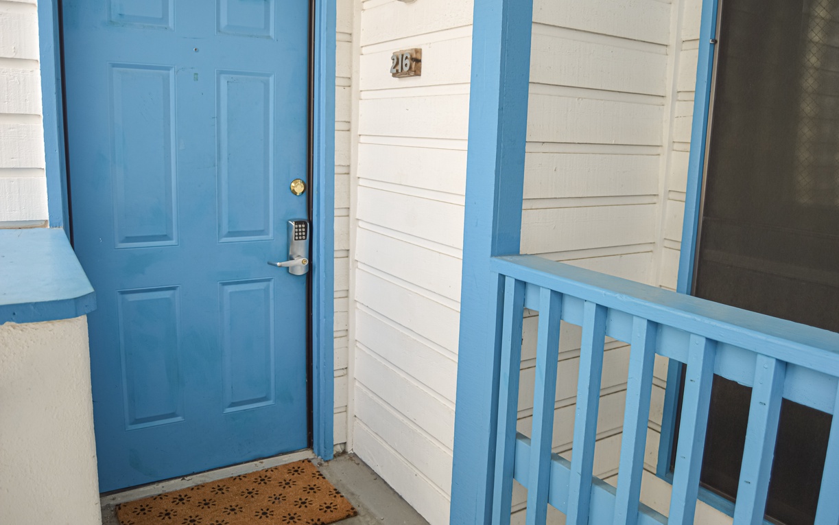 Bright blue entrance door welcomes you and includes a coded door lock for added security.