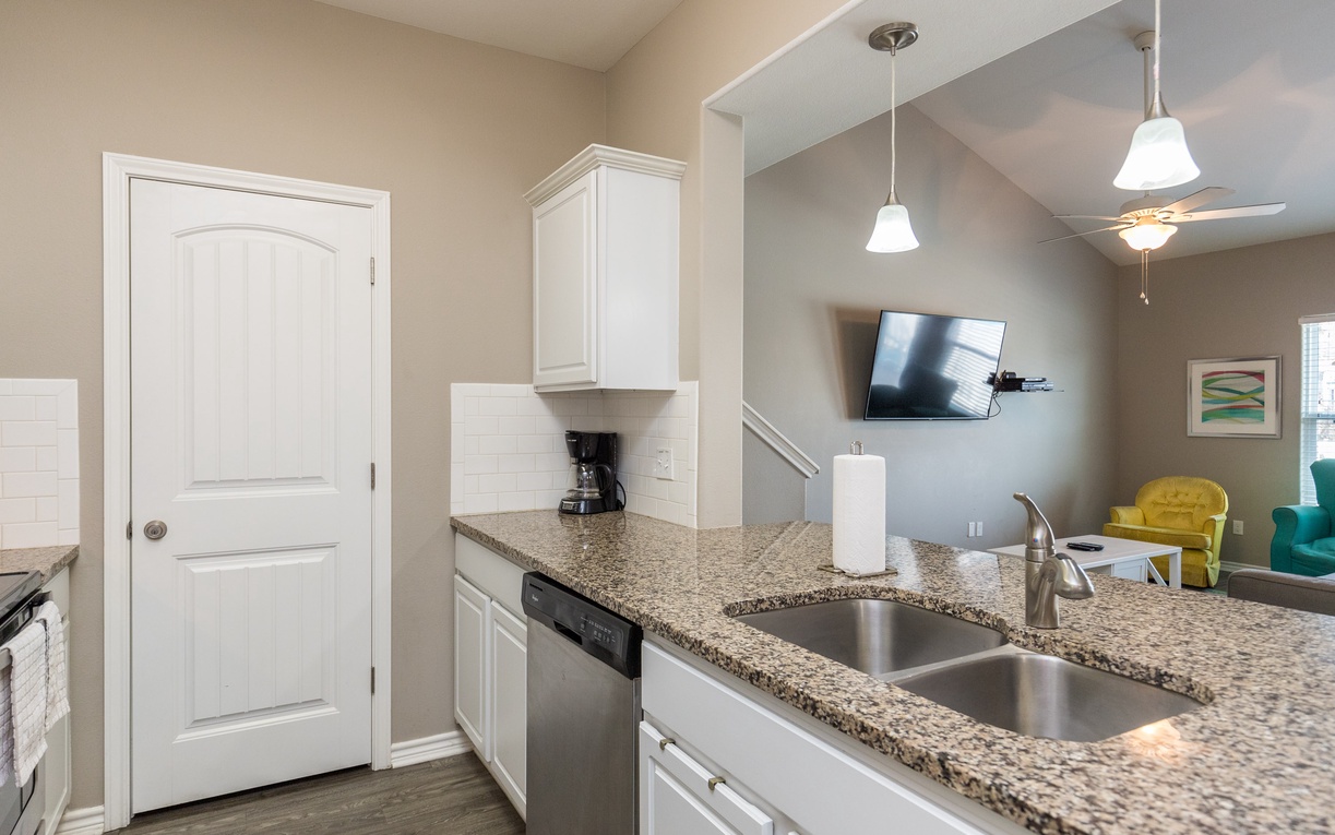 Your modern kitchen features granite countertops, stainless steel appliances, and an open design connecting to your cozy living area.