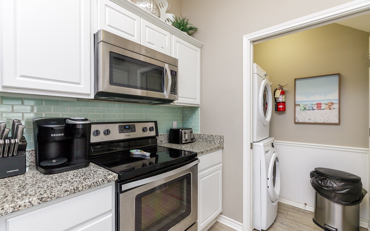Your fully equipped kitchen features modern appliances and granite countertops, with convenient laundry access right next door.