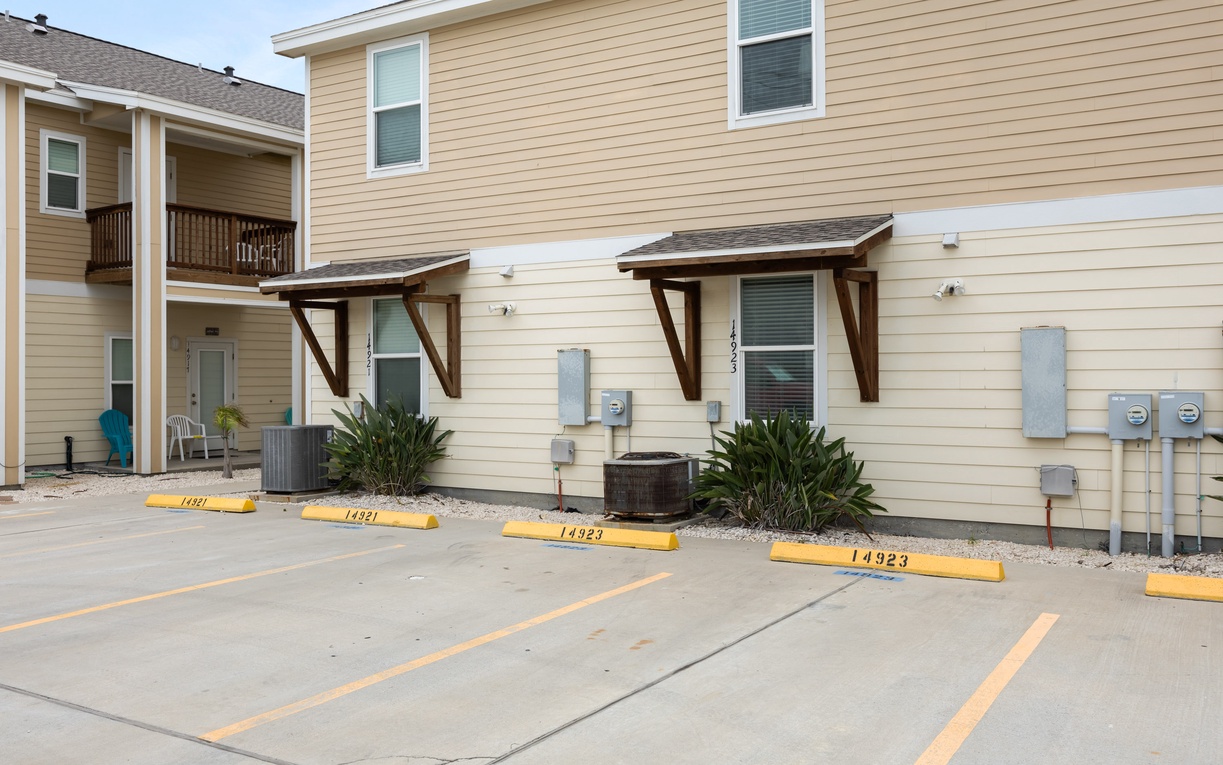 Modern townhome exterior with convenient parking spaces directly in front of your unit for easy access and unloading.