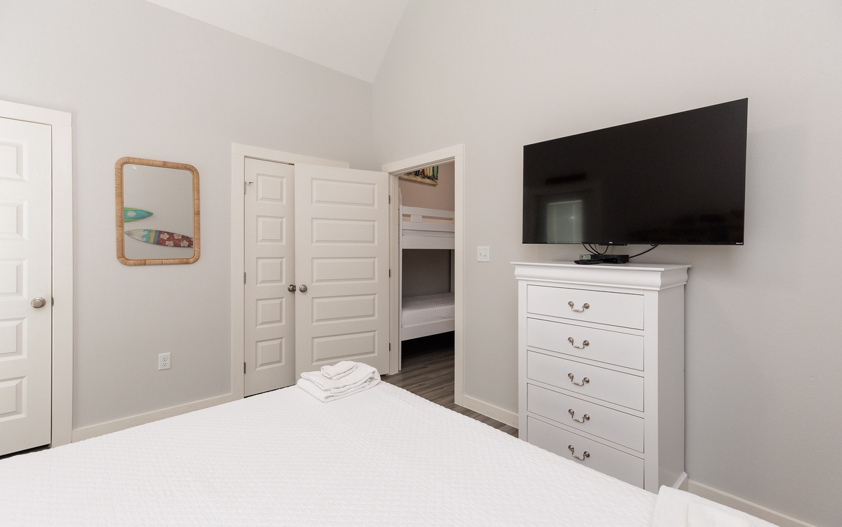 Unwind in your peaceful bedroom with plush linens, smart storage, and wall-mounted TV for cozy movie nights.