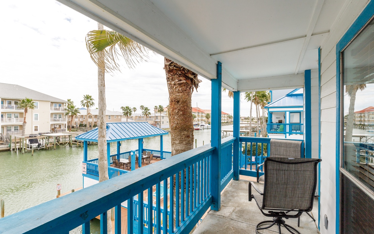 Your private waterfront balcony offers peaceful canal views and comfortable seating to enjoy tropical mornings with your coffee.