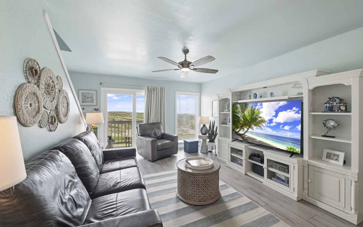 Unwind in your bright, breezy living space with coastal décor, plush seating, and a large TV—perfect for relaxing after a day of exploring the area.