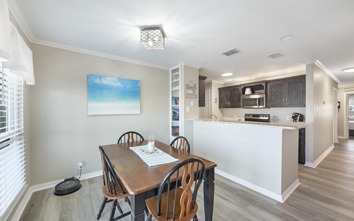 Gather around your spacious dining table, perfectly positioned next to the open kitchen for effortless entertaining and memorable meals together.