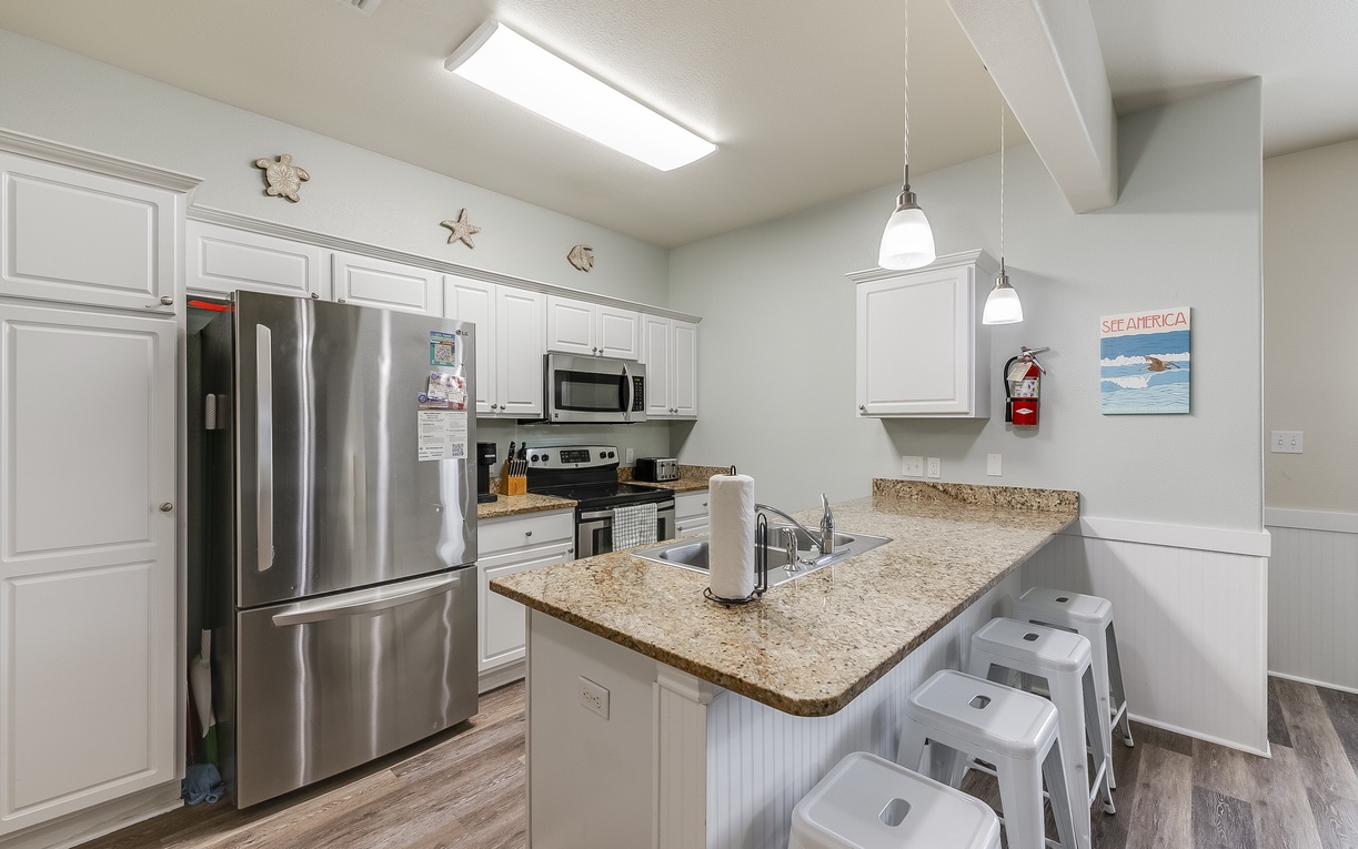 Your fully equipped kitchen features granite counters, stainless appliances, and a breakfast bar where you can start each morning with coffee.