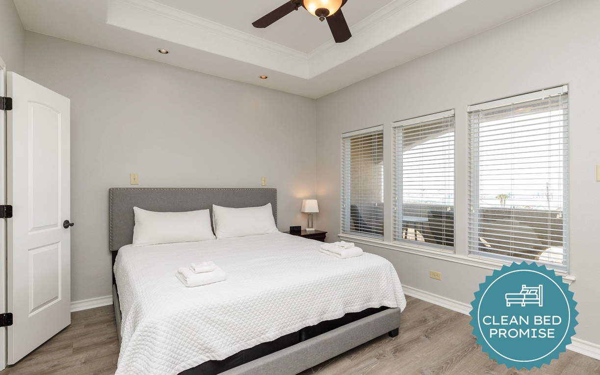 Settle into your serene bedroom sanctuary with crisp linens, gentle natural light, and a ceiling fan for perfect comfort.