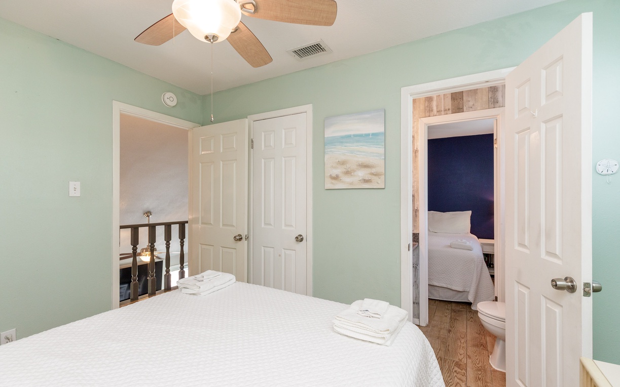 Drift off in your second bedroom with coastal artwork, queen bed and shared access to the bathroom.