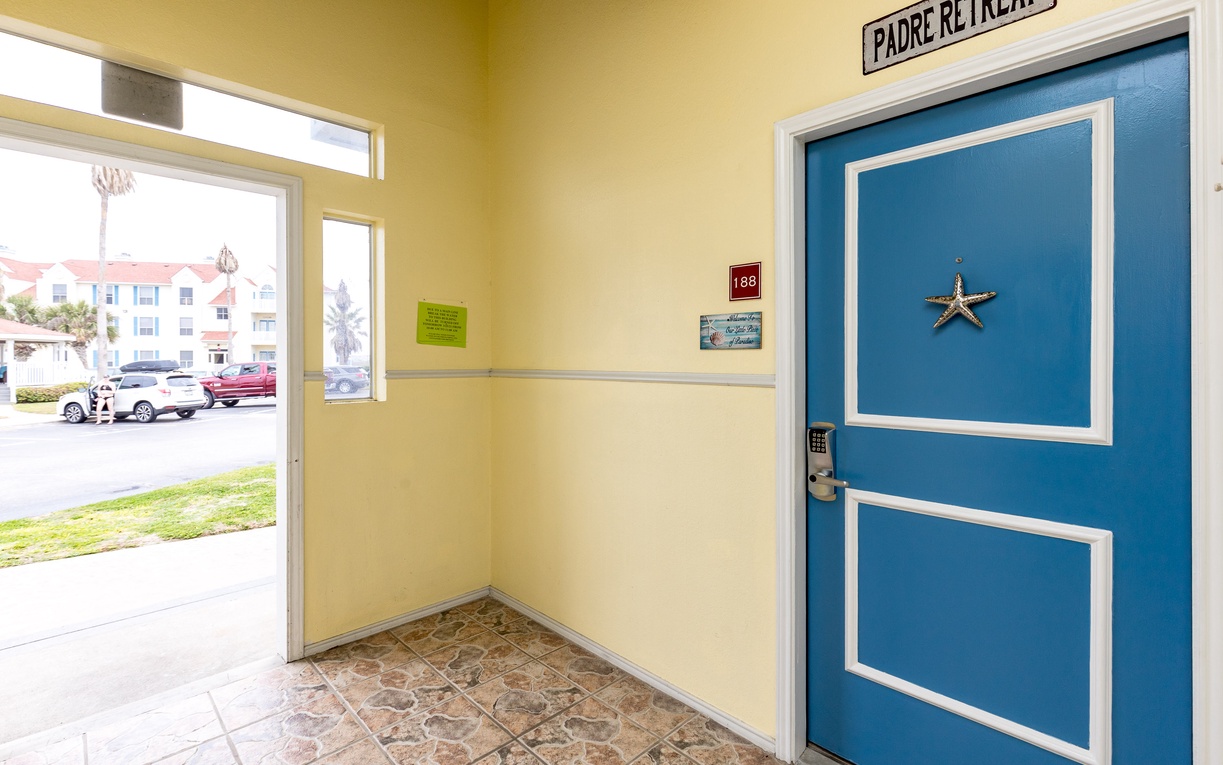 Step into your coastal retreat through this welcoming entrance, complete with cheerful decor and easy parking just outside your door.