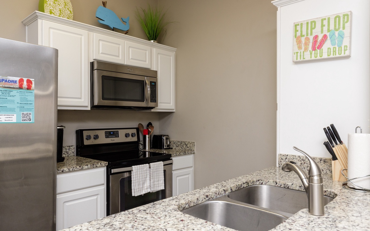 Your fully equipped kitchen features granite counters, stainless appliances, and everything needed to cook your favorite meals.