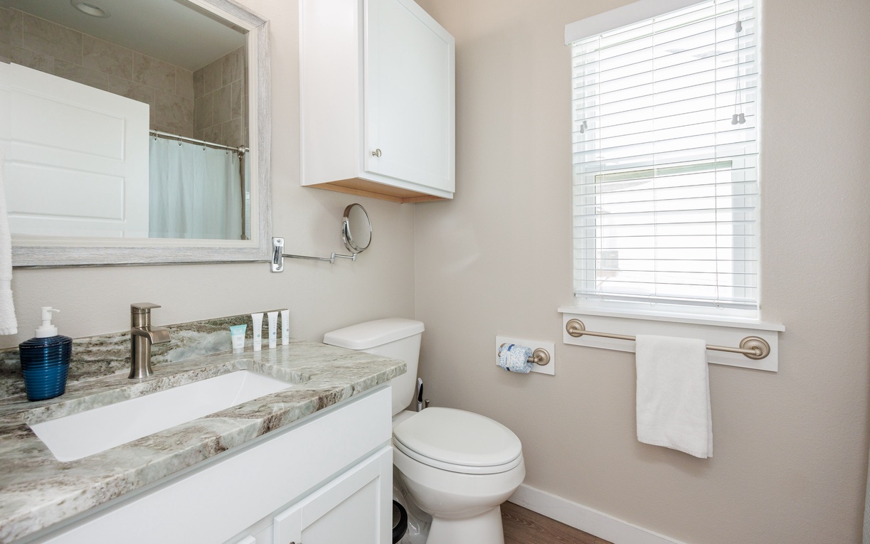 Your modern bathroom features elegant marble countertops, crisp white cabinetry, and everything you need to refresh after your daily adventures.