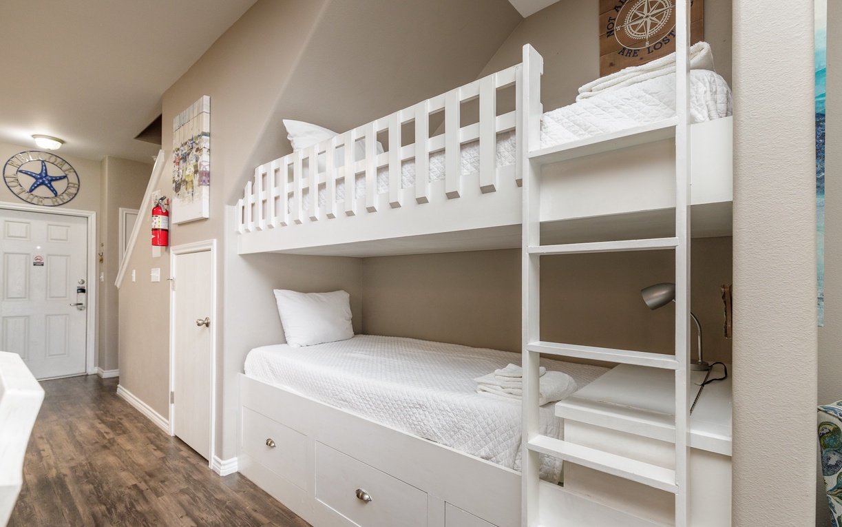 Sleep peacefully in your cozy nautical-themed twin bunk beds with built-in storage and thoughtful touches throughout.