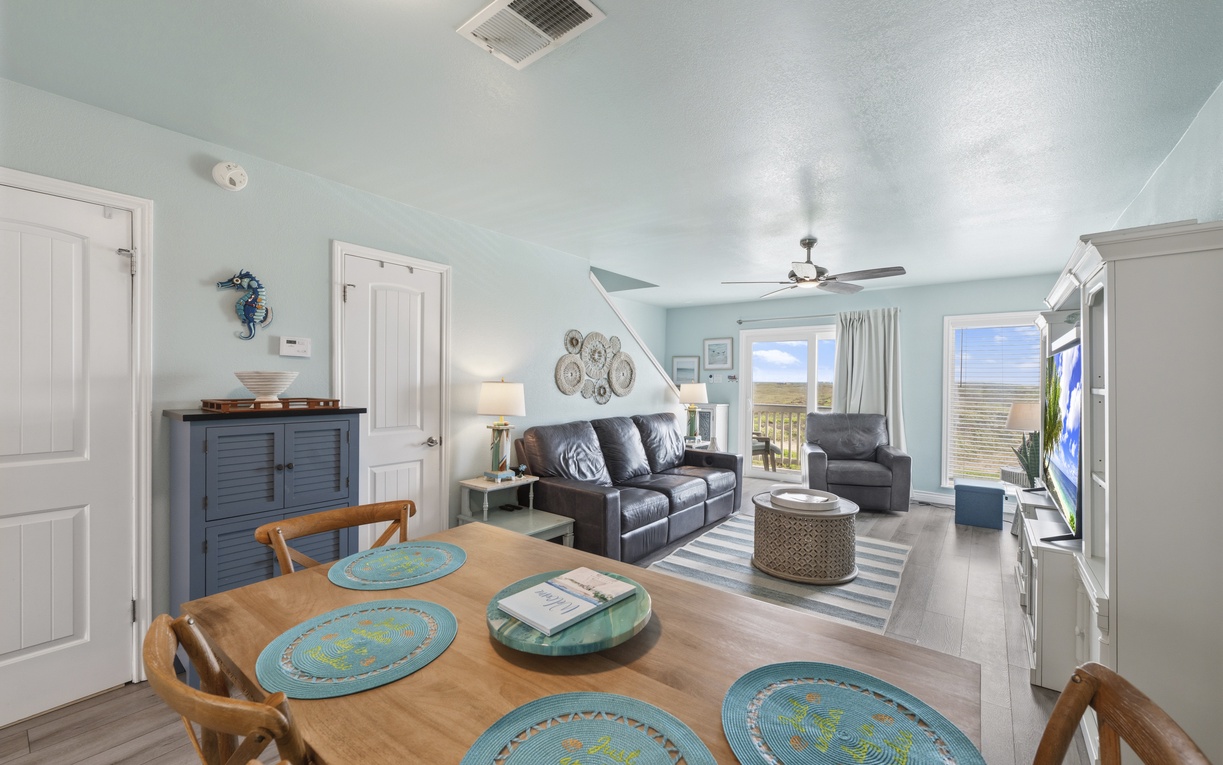 Gather, relax, and unwind in this airy beach-inspired living and dining space with natural light and coastal charm.