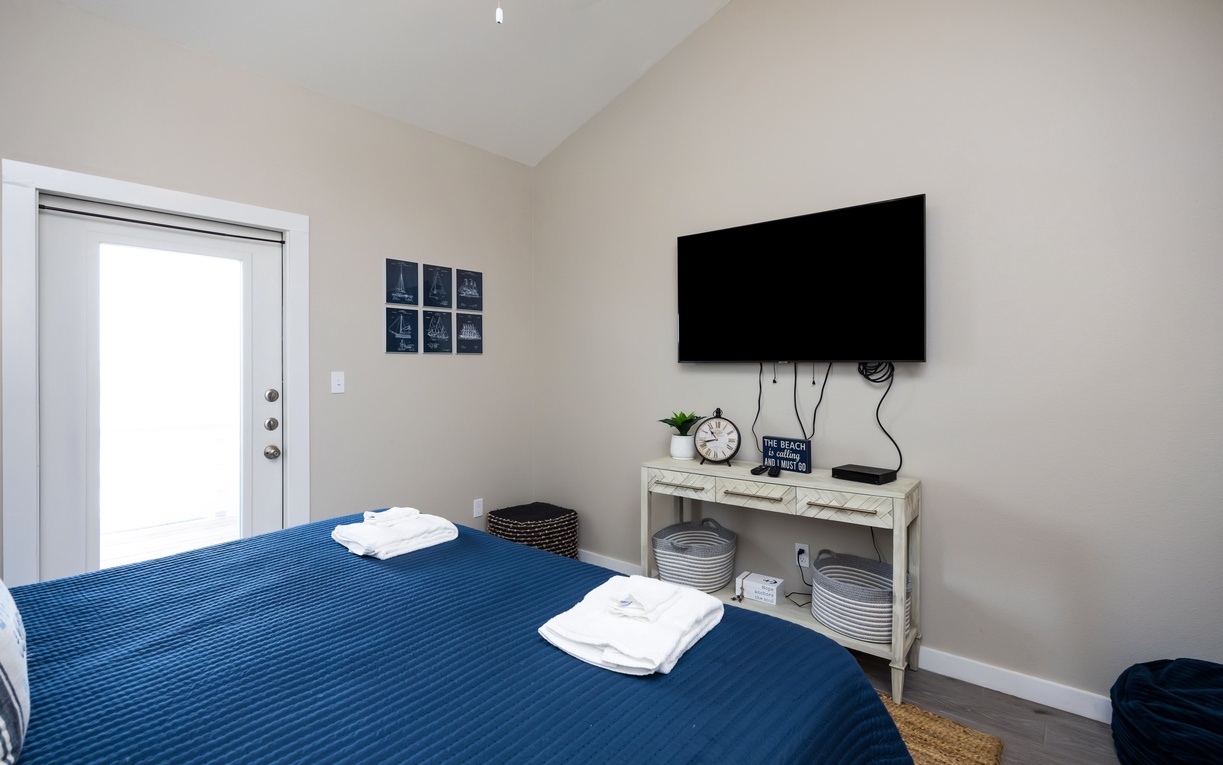 Unwind in your cozy bedroom with a large flat-screen TV for movie nights and fresh towels ready for your comfort.