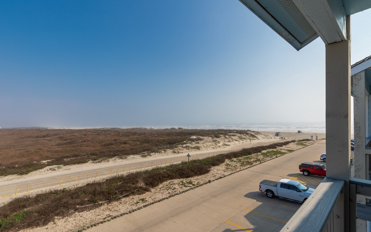 Expansive coastal view from the primary bedroom balcony.
