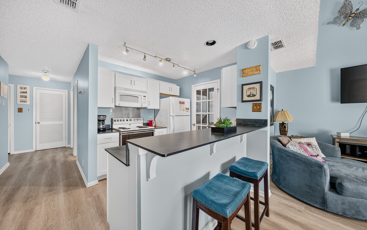 Relax in your bright open-plan space with a fully equipped kitchen, cozy breakfast bar, and comfortable living area perfect for unwinding after exploring.