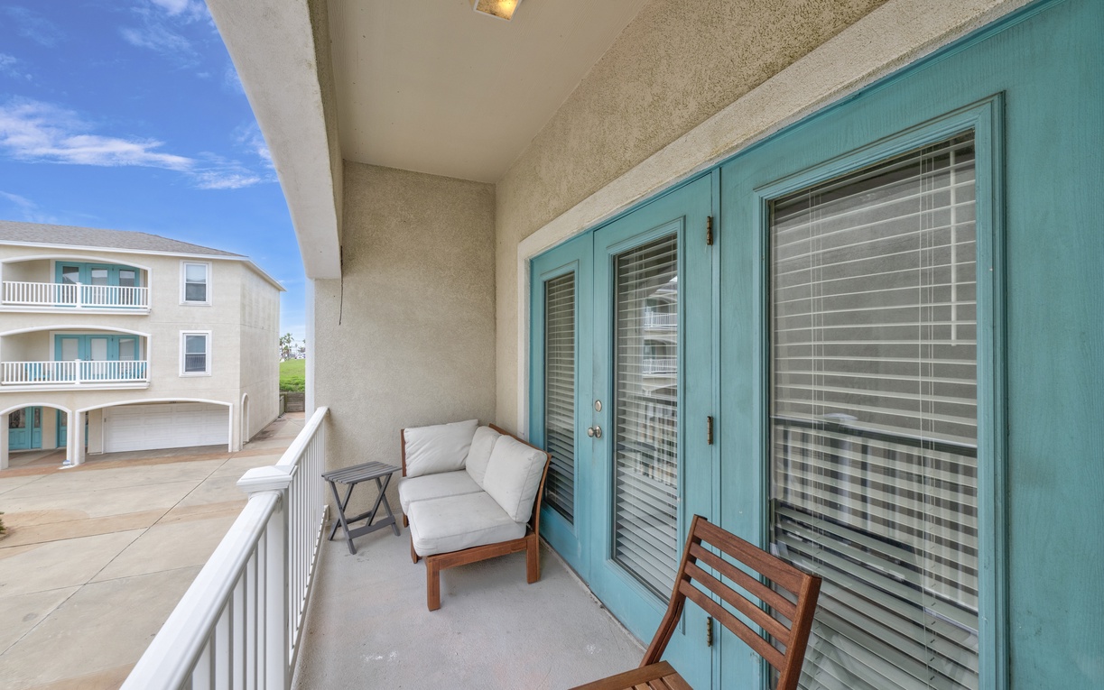 Your private balcony offers comfortable seating where you can relax with morning coffee while enjoying coastal breezes and peaceful neighborhood views.