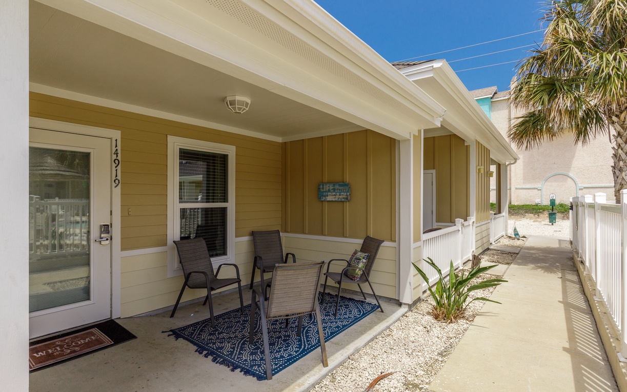 Step onto your private covered patio and settle into comfortable seating where ocean breezes and tropical vibes create the perfect spot for morning coffee.