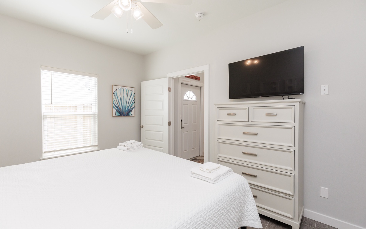 Sink into crisp white linens in your peaceful bedroom, complete with smart storage and entertainment for ultimate relaxation.
