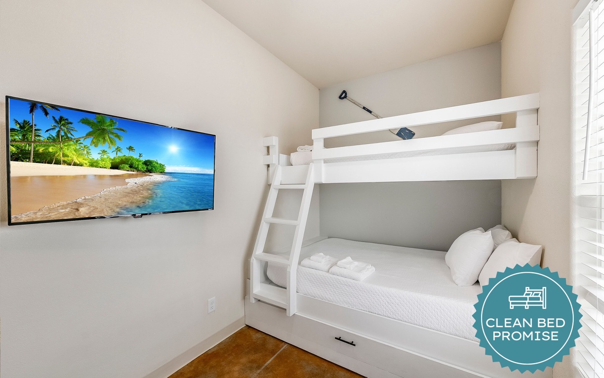 Cozy bunk beds with crisp linens and tropical TV views create your perfect family retreat.