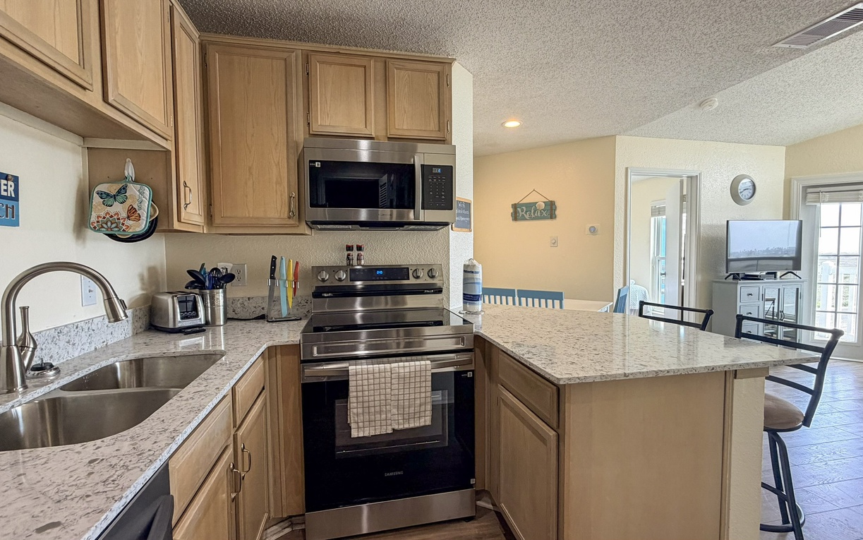 Enjoy preparing meals in your spacious kitchen featuring granite countertops, stainless appliances, and breakfast bar seating.
