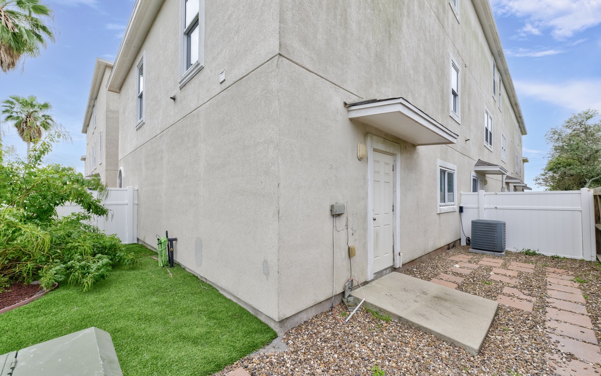 Modern two-story townhome with private entrance and landscaped yard in a quiet residential setting.