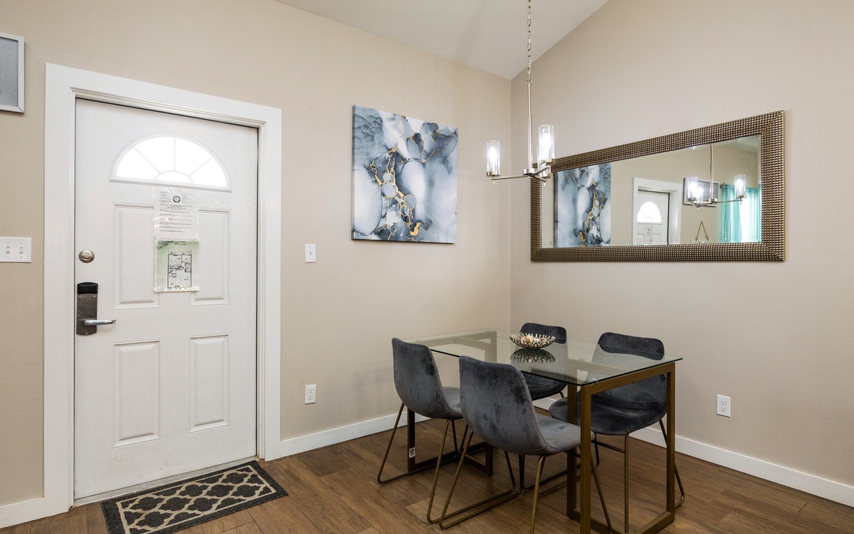 Enjoy intimate meals in your elegant dining space, featuring stylish chairs and modern pendant lighting that creates the perfect ambiance.