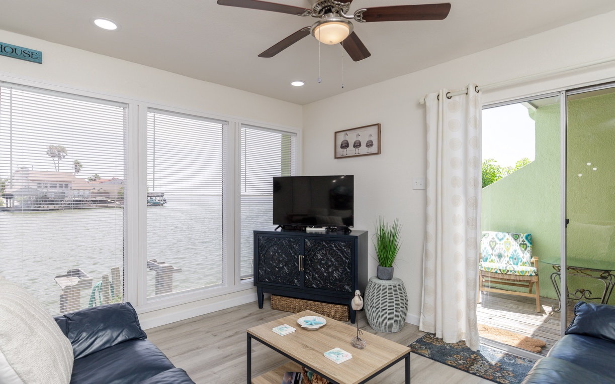 Relax in your bright living room with water views, comfy seating, and direct patio access for seamless indoor-outdoor living.