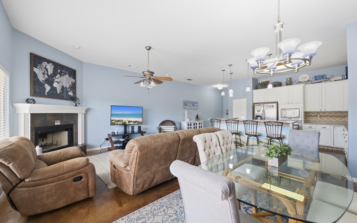 Relax in your spacious open-concept living area, where cozy seating, and modern kitchen flow seamlessly together for memorable gatherings.