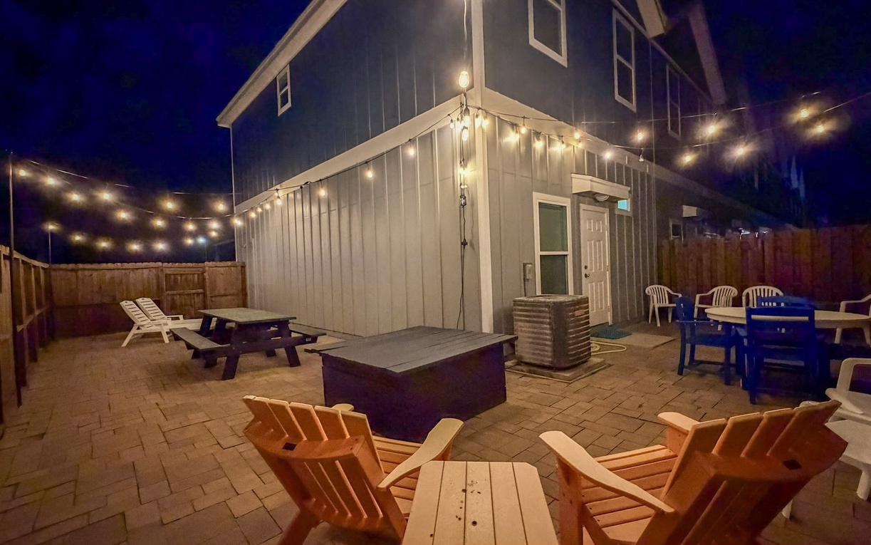 Step into your private backyard oasis where twinkling string lights illuminate cozy seating areas perfect for evening gatherings.