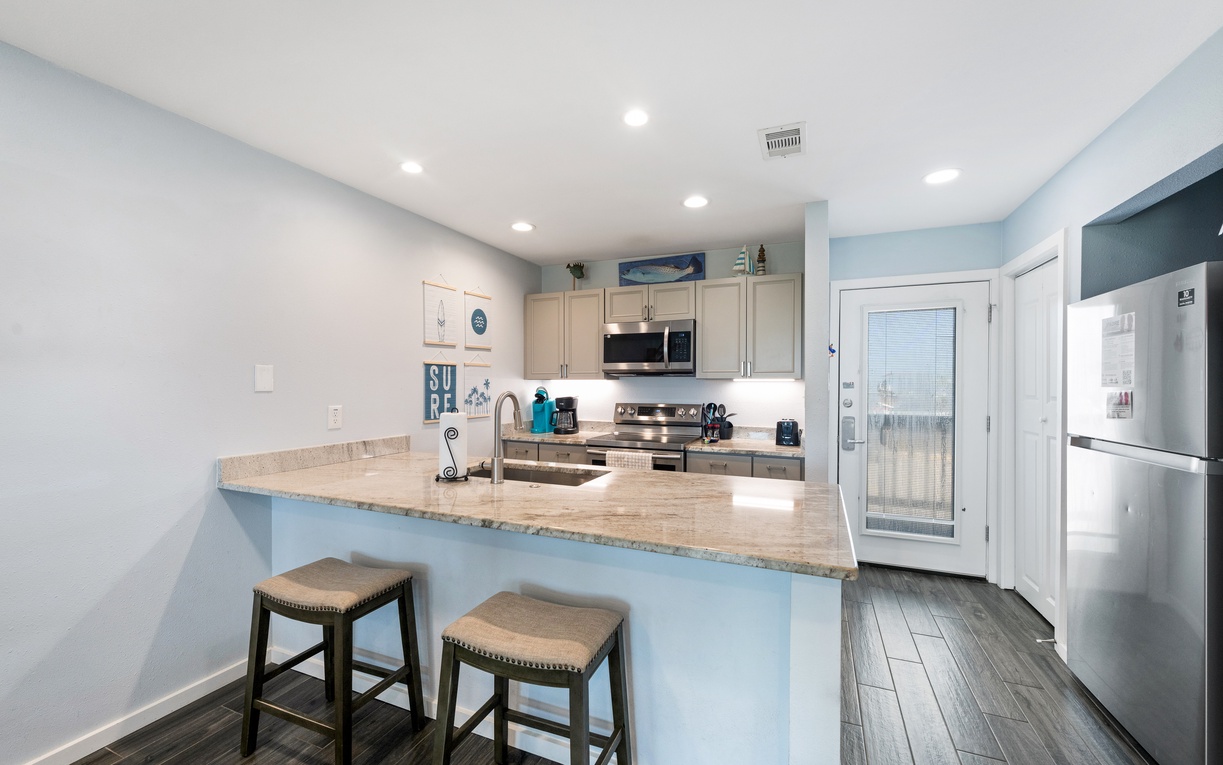 Your fully equipped kitchen features a breakfast bar for casual dining, sleek granite countertops, and all the modern appliances you'll need to whip up your favorite meals.