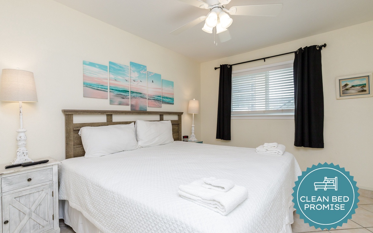 Drift off to sleep surrounded by coastal charm in your peaceful bedroom with crisp linens and soothing ocean artwork.