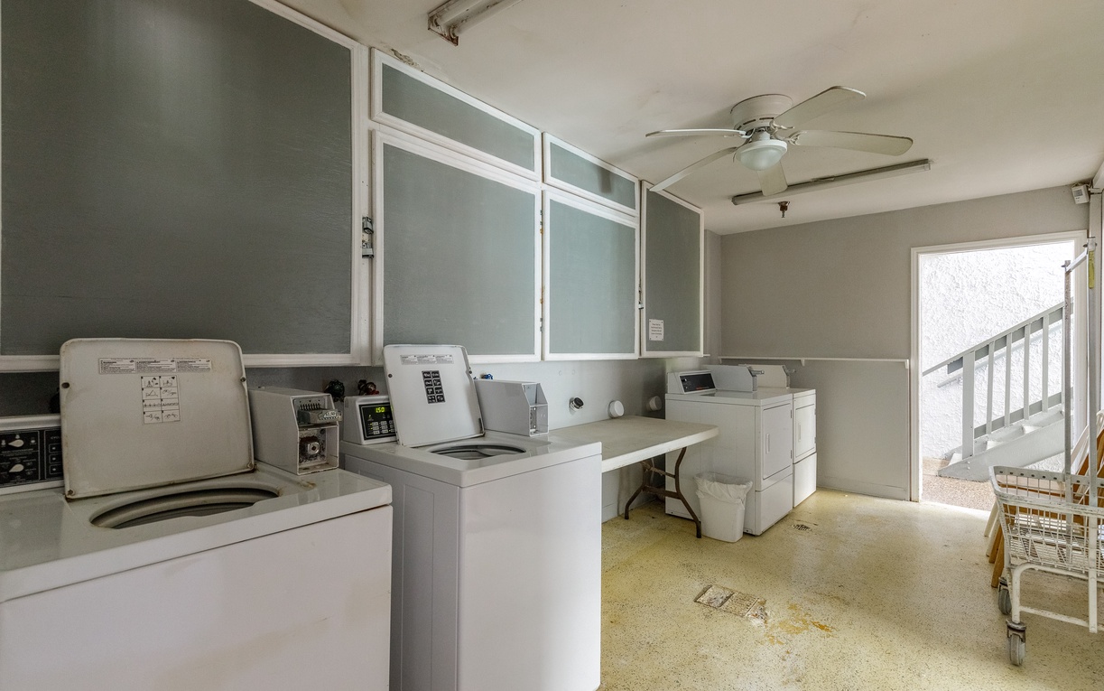 Handle laundry effortlessly in this well-equipped facility with multiple machines and convenient basket storage for your convenience.