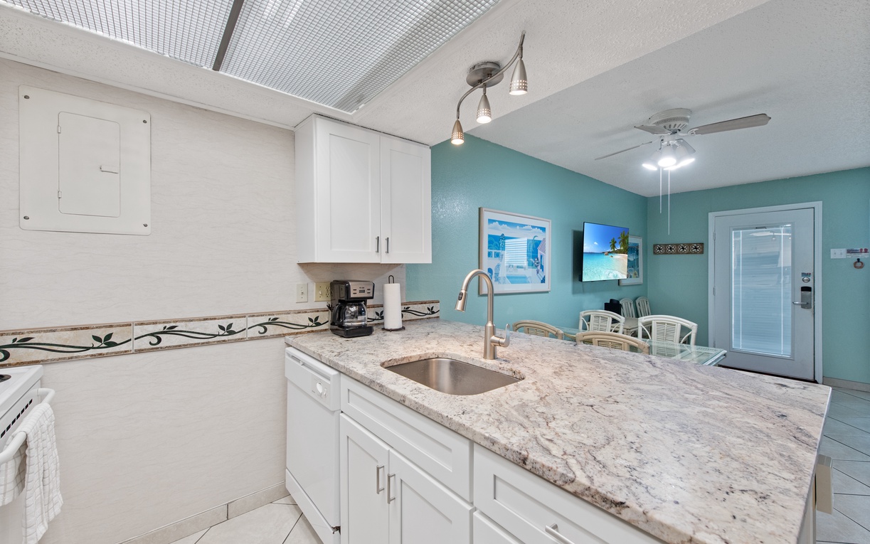 Your bright coastal kitchen awaits with granite countertops and modern appliances for memorable vacation meals.