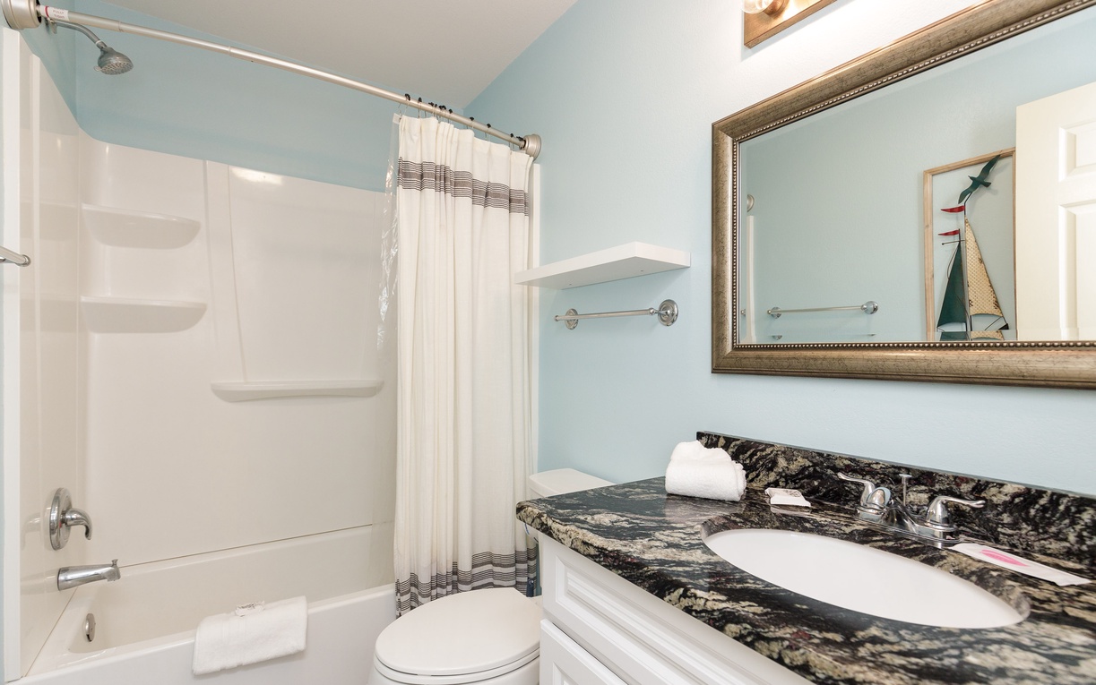 Your beautifully appointed bathroom features granite counters, warm lighting, and a relaxing tub-shower combo for unwinding after your adventures.