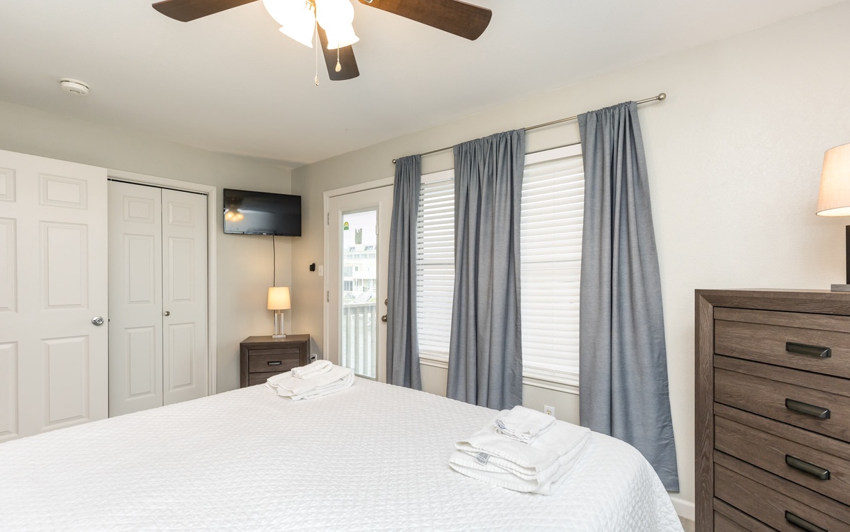 Drift off to peaceful sleep in your cozy bedroom, complete with ceiling fan, blackout curtains, and thoughtful touches for comfort.