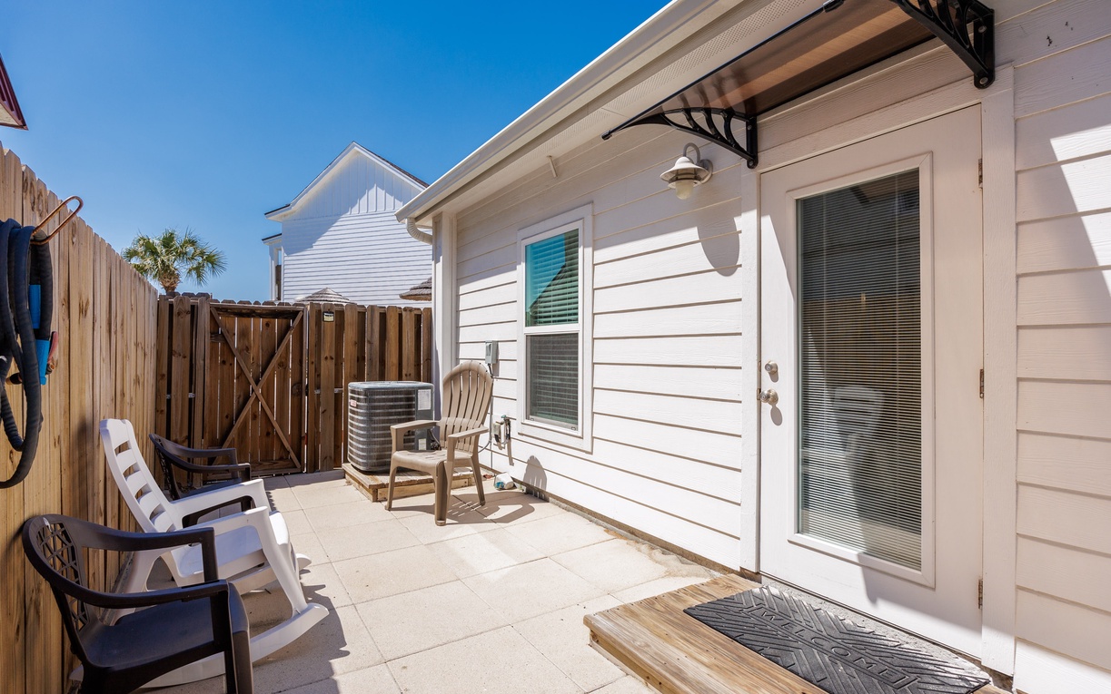 Your private patio offers sunny relaxation with comfortable seating and AC unit for perfect climate control after beach adventures.