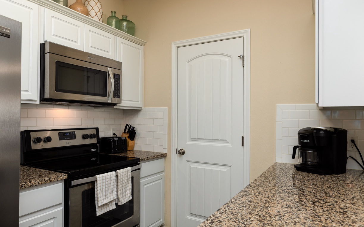 Step into your fully equipped kitchen with granite countertops, stainless appliances, and everything needed for home-cooked meals.