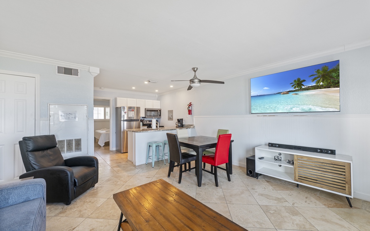 Your bright open-plan living space seamlessly blends comfort and style, with a fully equipped kitchen, dining area, and cozy seating perfect for relaxing.