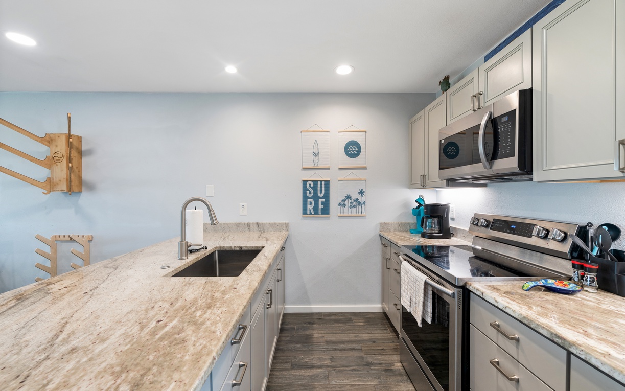 Step into your fully equipped kitchen where beach-themed décor and granite counters set the perfect coastal mood. Everything you need for easy meal prep is right at your fingertips.
