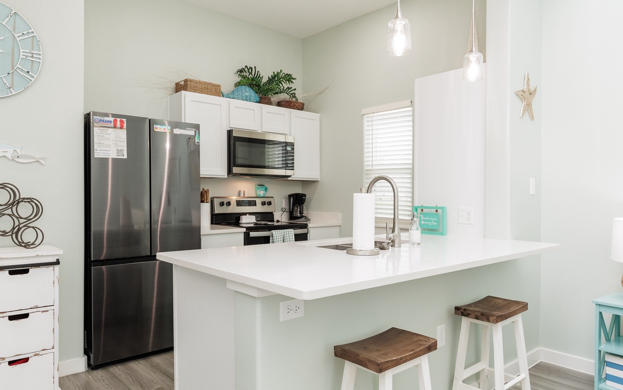 Your bright, fully-equipped kitchen features stainless steel appliances and a breakfast bar where you can enjoy morning coffee.