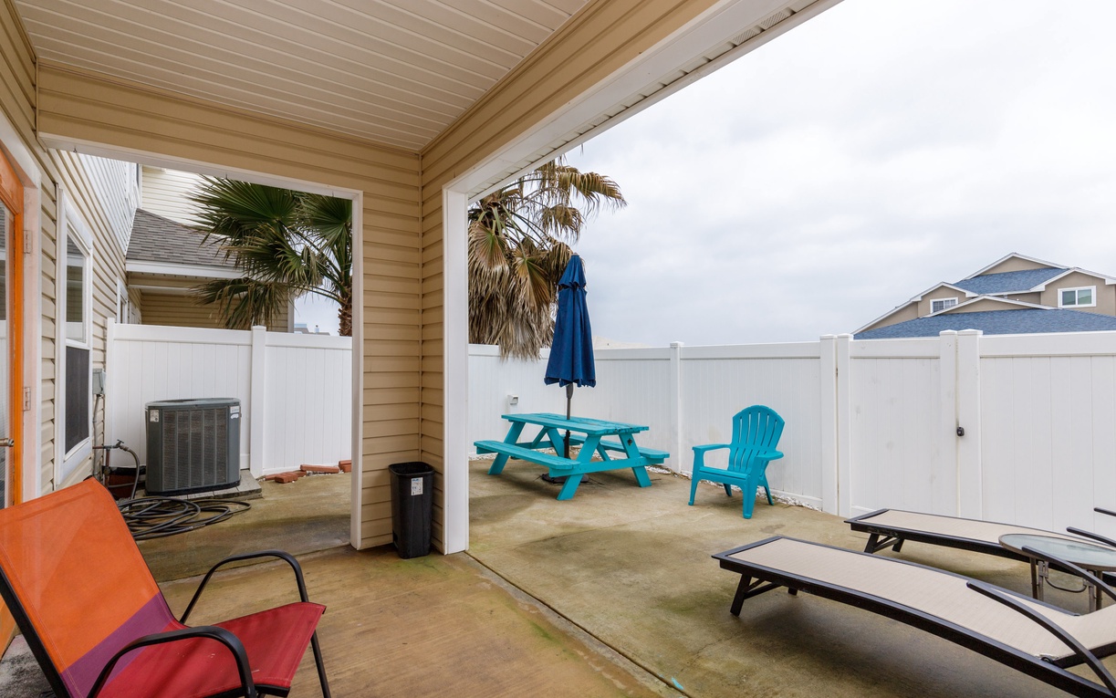 Your private patio features colorful outdoor furniture and tropical palm trees for perfect relaxation.