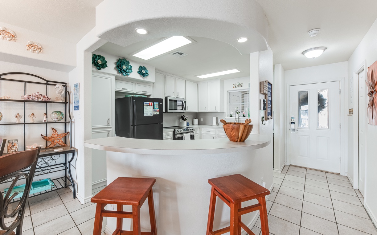 Gather around your bright, fully-equipped kitchen with curved counter seating and modern appliances for memorable meal prep together.