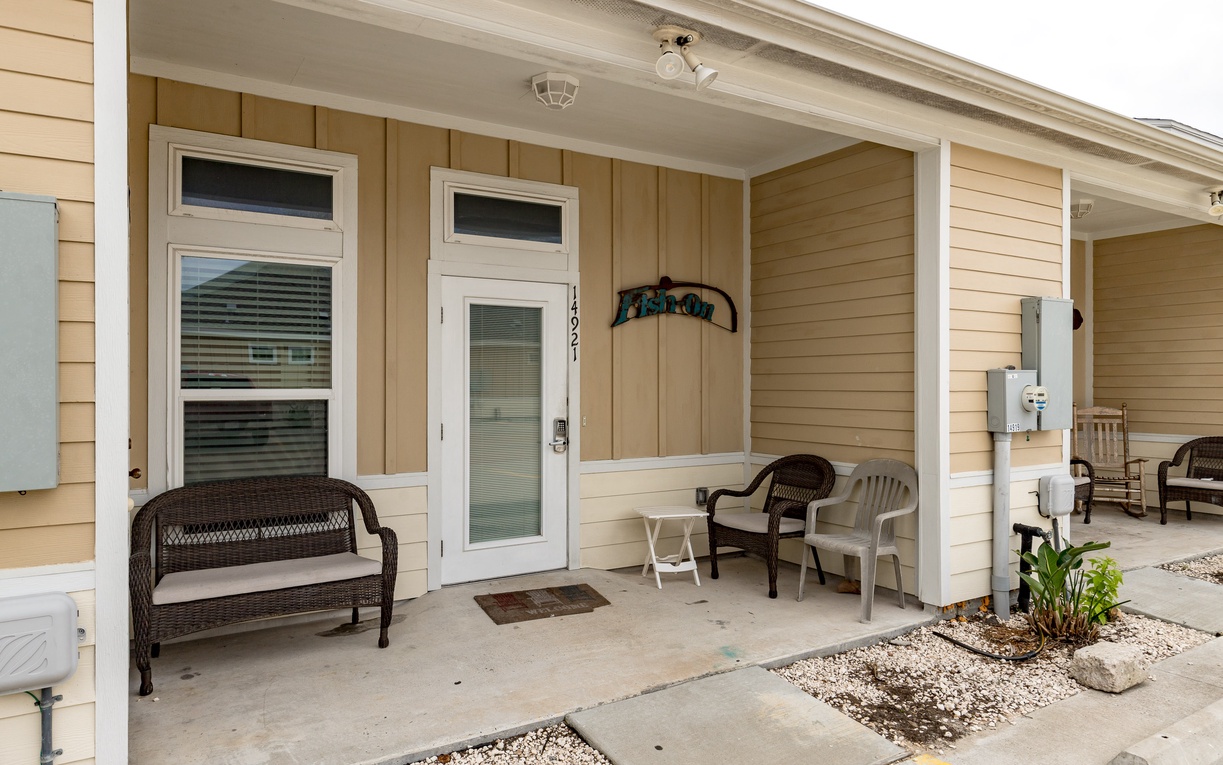 Your welcoming front porch with comfortable seating invites you to unwind with morning coffee or evening conversation in this peaceful setting.