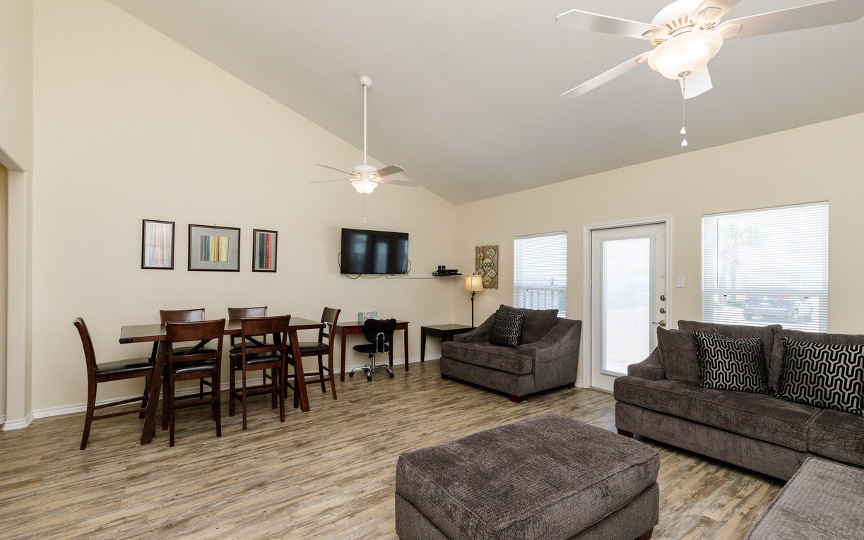 Relax in your spacious open-concept living area with comfortable seating, dining space, and modern amenities for the perfect home away from home.