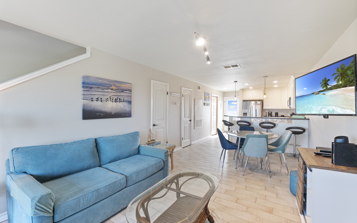 Step into your coastal-inspired haven where turquoise accents and beach artwork create the perfect retreat atmosphere.