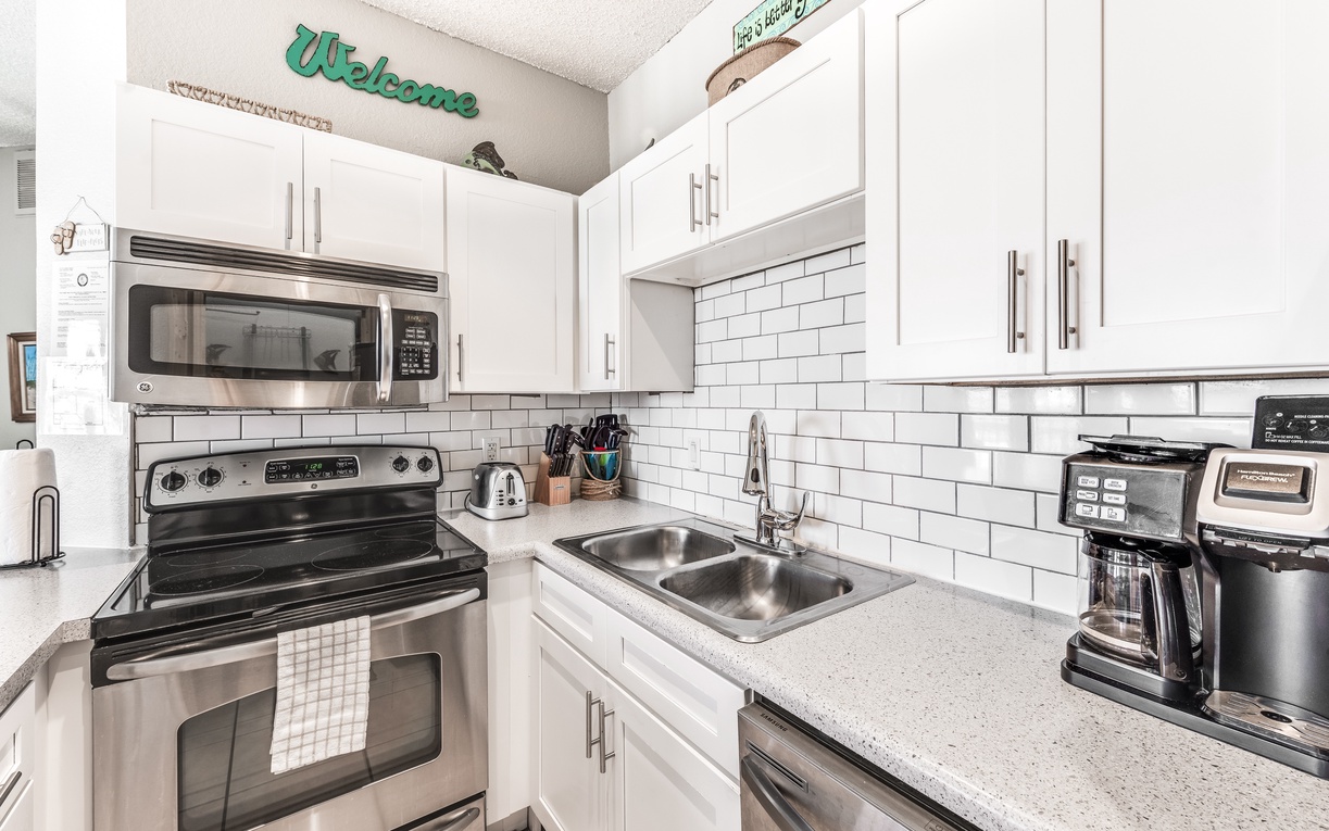 Your fully equipped kitchen features modern appliances, granite countertops, and crisp white cabinetry for effortless meal preparation.
