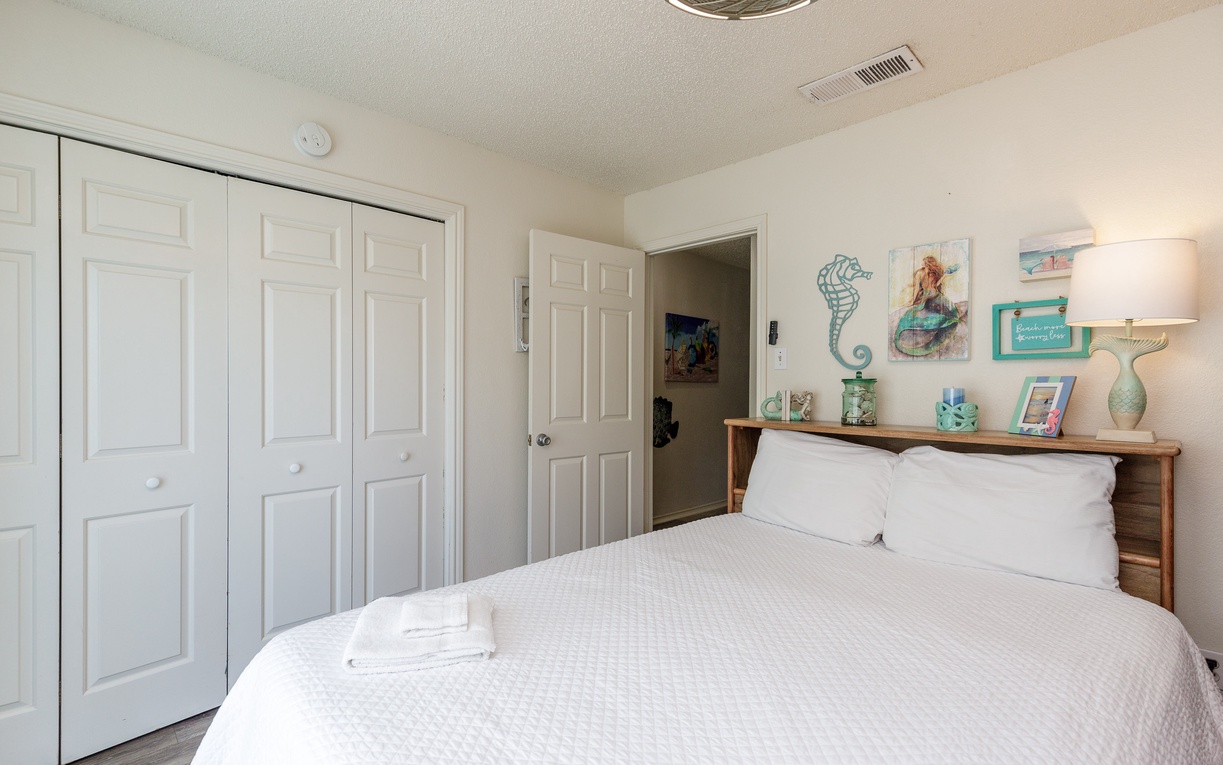 Sink into crisp linens and coastal charm in your peaceful bedroom retreat, complete with thoughtful beachy touches.