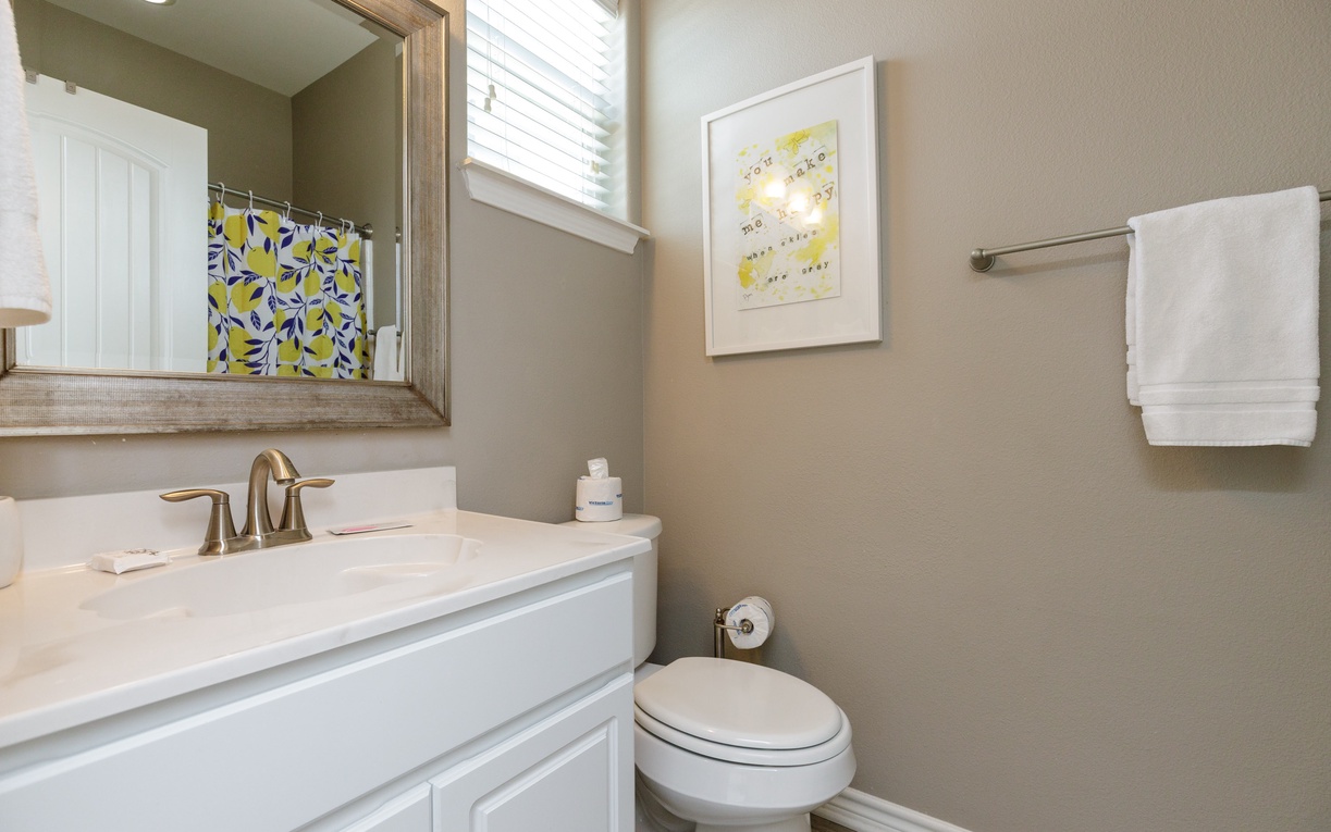 Your private bathroom features a spacious vanity with ample counter space, soft lighting, and fresh towels ready for your stay.