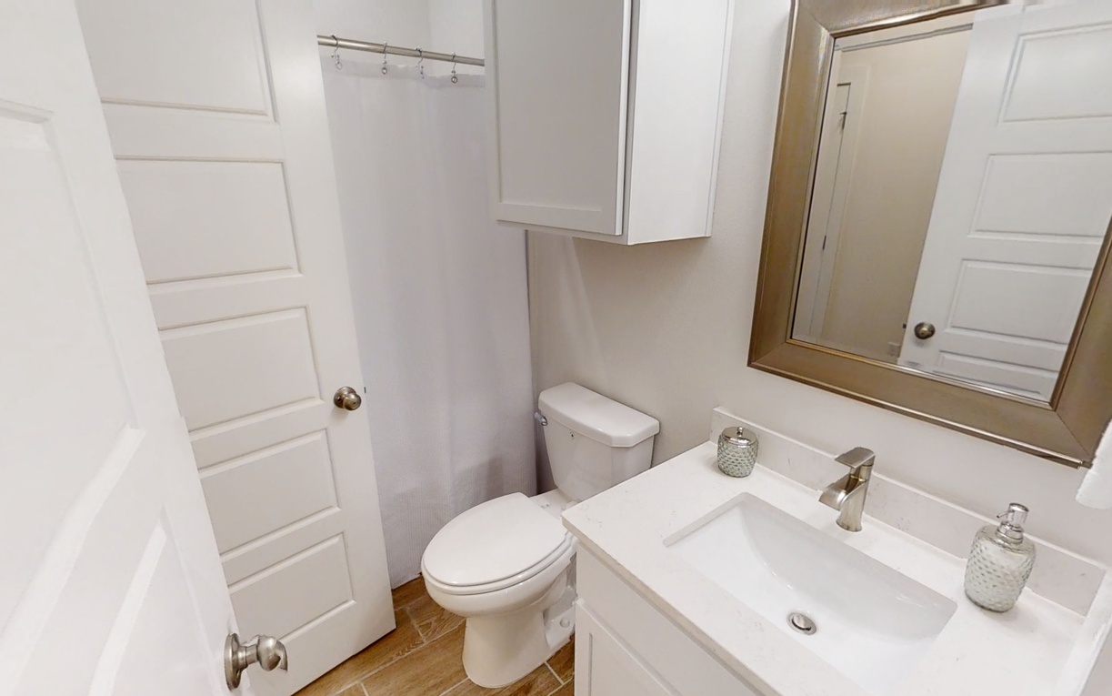 Your private bathroom features crisp white finishes and thoughtful amenities for a refreshing start to your day.