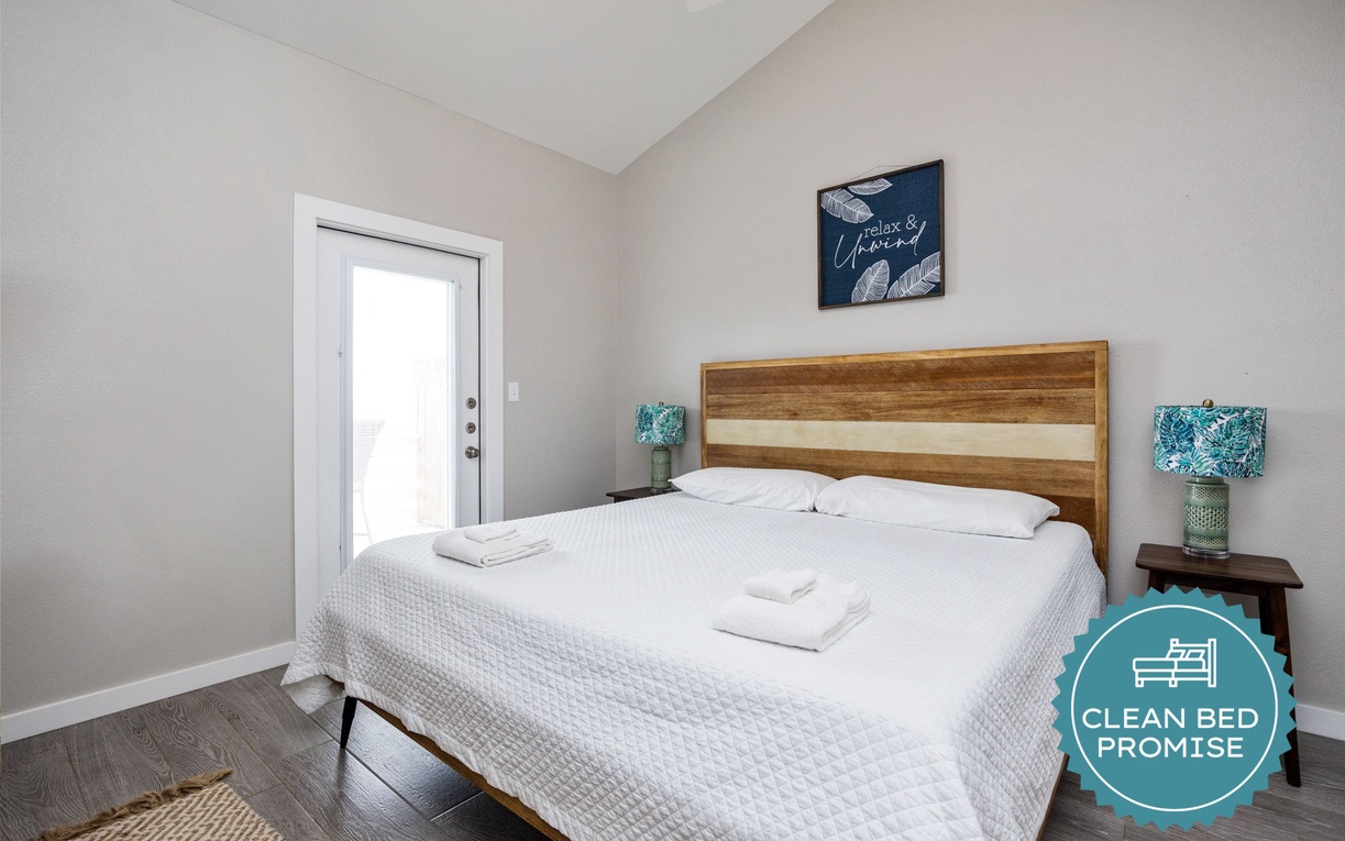 Sink into crisp white linens and wake refreshed in your serene bedroom with warm wood accents and thoughtful touches.